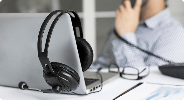 Woman holding pair of headphones